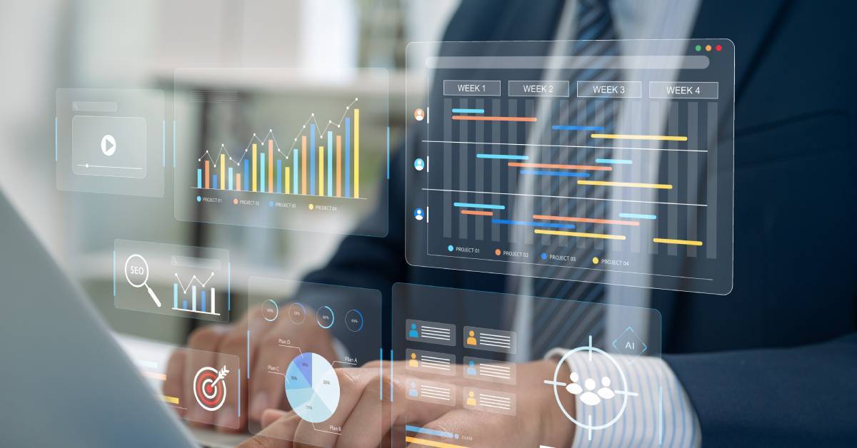 A man in business attire types on a laptop. In front of him is a transparent overlay of different data graphs.