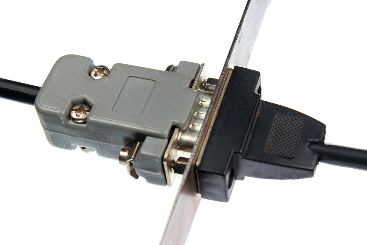 Close-up to the male end of an RS232 smart cable plugged into the female end of another cable in white background.